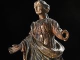 an antique statue of a woman with her arms outstretched and hands out