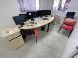 three computer screens on the desk in this office