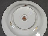 a white plate with a crown on it sitting on a table