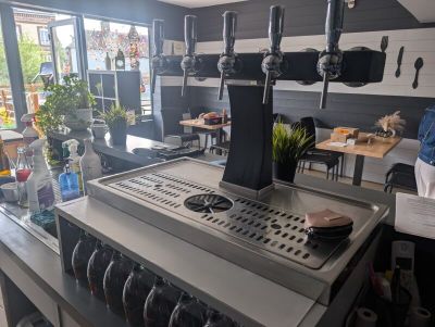 a counter that has a bunch of wine glasses on it