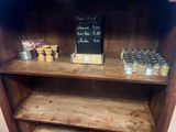 a wooden shelf with a chalk board on top of it