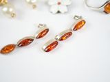 several pieces of jewelry are arranged on a white surface