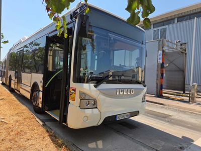 a white bus that is parked on the side of the road