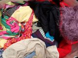 a large pile of clothes in a metal bowl
