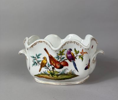 a white bowl with birds and flowers painted on it