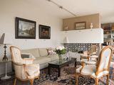 a living room with a couch, chairs, and a coffee table