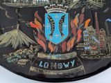 a black plate with a picture of a city on it