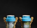 two blue vases with paintings on them sitting next to each other