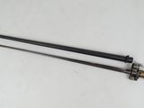 a pair of two black and gold swords sitting on top of a white surface
