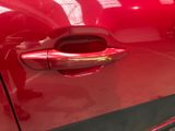 a close up of a red car door handle