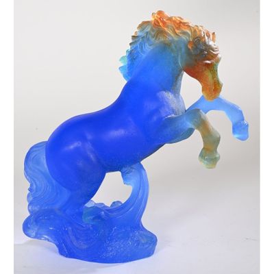 statue of a blue horse with orange mane standing on its hind legs