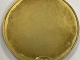 an image of a gold coin on a white surface