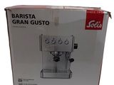 the box of a coffee machine is open on a white surface