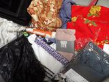 a pile of clothes and a purse on the floor