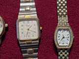 three different types of watches are displayed on a red surface