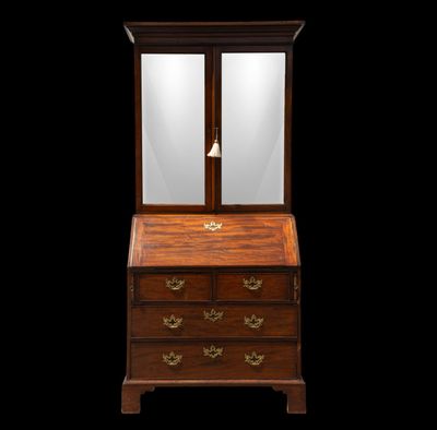 an antique wooden desk with a mirror on top of it
