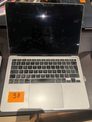a laptop computer sitting on a table with a price tag on it