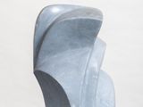 sculptures are displayed on a white pedestal against a white background