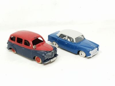 two toy cars sitting next to each other on a white surface