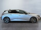 the silver car is parked on the concrete floor in the room