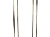 a pair of brass and glass floor lamps