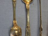 three spoons and a spoon rest on a gray surface