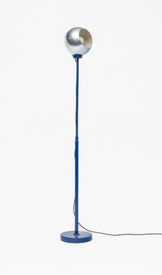 the floor lamp has a blue base and a silver ball on it
