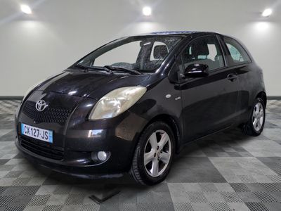 une photo d'une Toyota Yaris noire garée sur un sol à damier