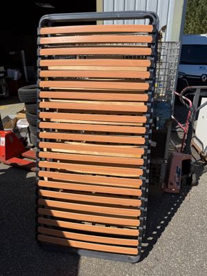 a stack of wooden slats on a cart in the parking lot