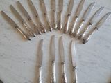 a lot of knives that are sitting on a table