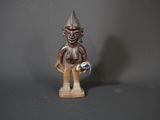wooden statue of a man with a hat and a bird on his shoulder