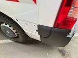 a white van with a red stripe parked in a parking lot