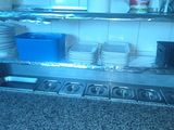 many plates and pans on the shelf in the kitchen