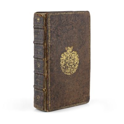 un vieux livre avec une pomme dorée sur la couverture