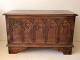 an old wooden chest sitting on top of a carpeted floor