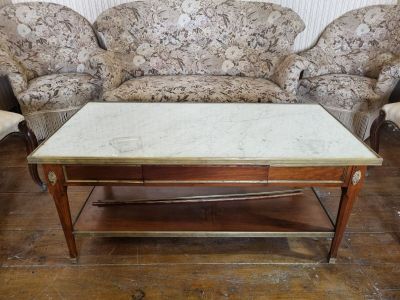 a marble top coffee table in the middle of a living room