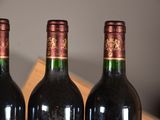three bottles of wine that are sitting on a table