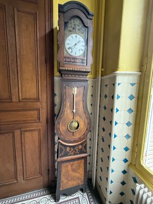 a grandfather clock in the corner of a room
