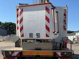 a white truck with a red and white stripe on the back