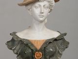 a bust of a woman wearing a hat on a table