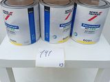 four cans of paint sitting on a table next to a cardboard box