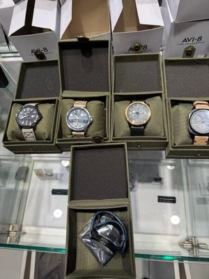 several watches are displayed in a display case on a glass table