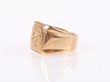 an image of a gold signet ring with a cross on it