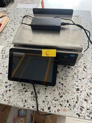 a tablet computer sitting on top of a table next to a laptop