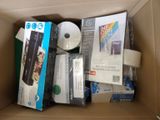 a cardboard box filled with various electronic devices and other items