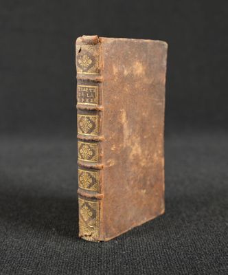 an old book sitting on top of a black surface
