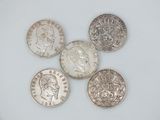 six different british coins on a white surface, one of which has a crown and the other of which is