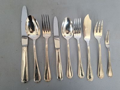tout un service d'argenterie sur une table, avec un couteau, une fourchette et une cuillère