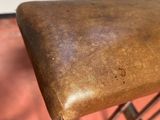 leather seat on a rocking chair in a room with a red floor