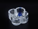 a clear glass cup with a blue lid on a black surface